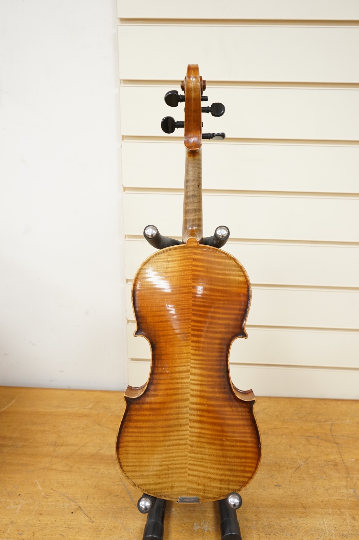Four violins; a German Dresden violin, together with further two German violins, and a Saxony violin, three in cases or the remains of cases.